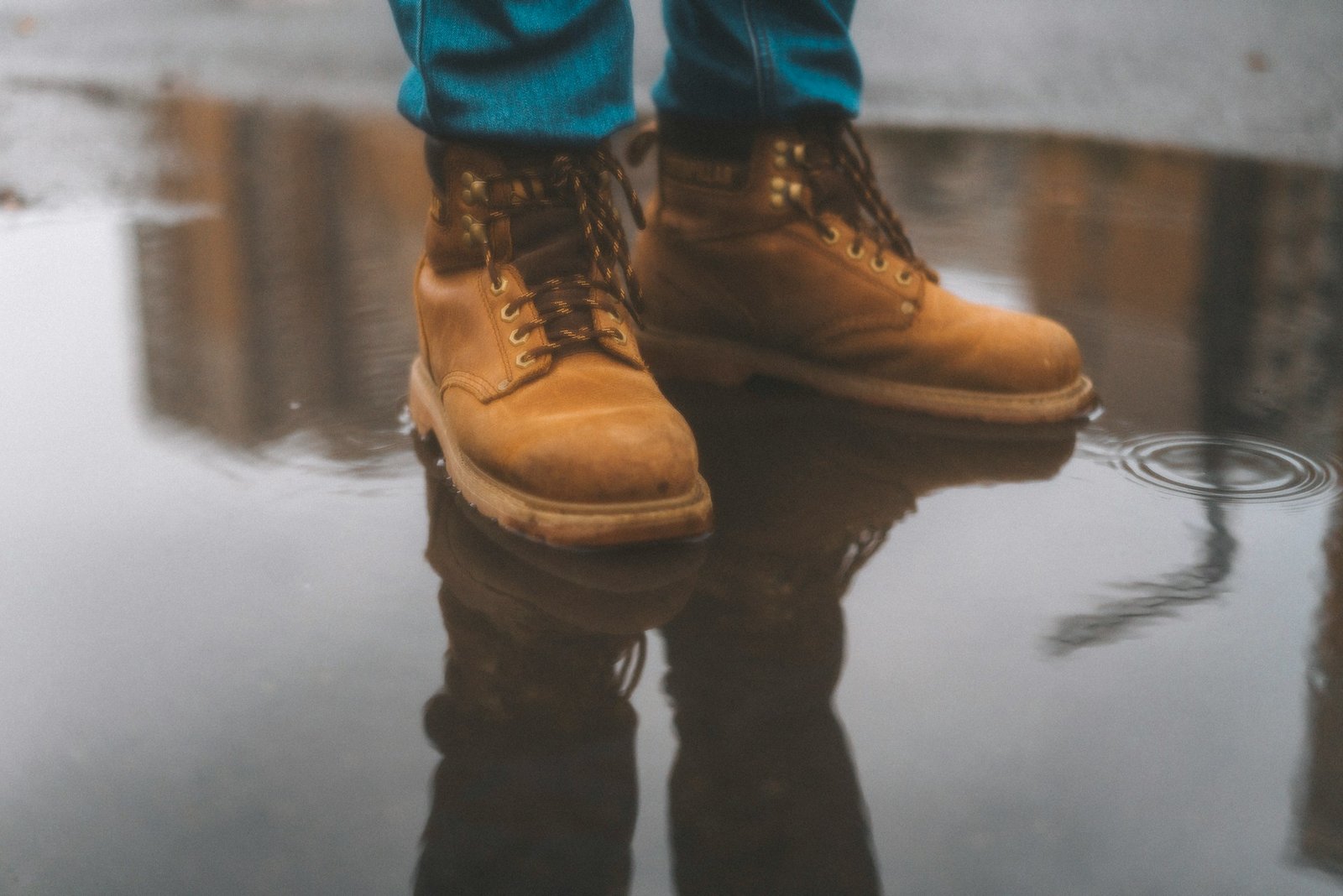 a man in yellow shoes and blue jeans
