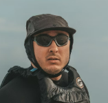 a man wearing glasses and a black jacket