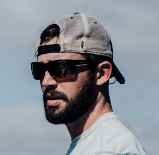 a man with a beard wearing a cap and glasses